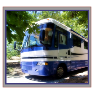 Large RV surrounded by trees.