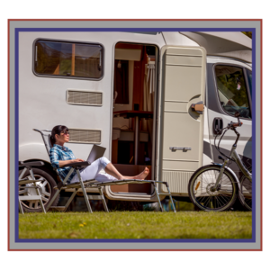 woman reading a book outside of her rv