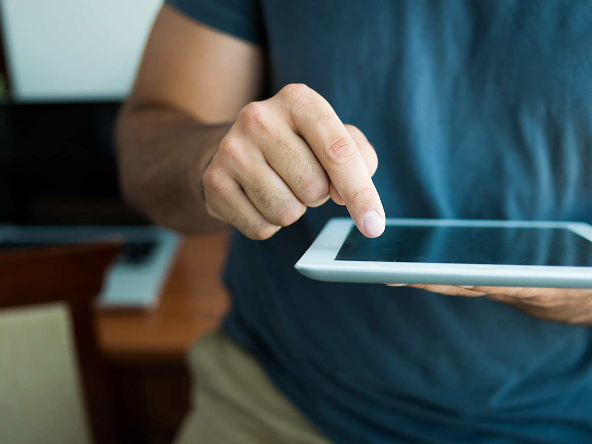 A man checking reviews on his tablet