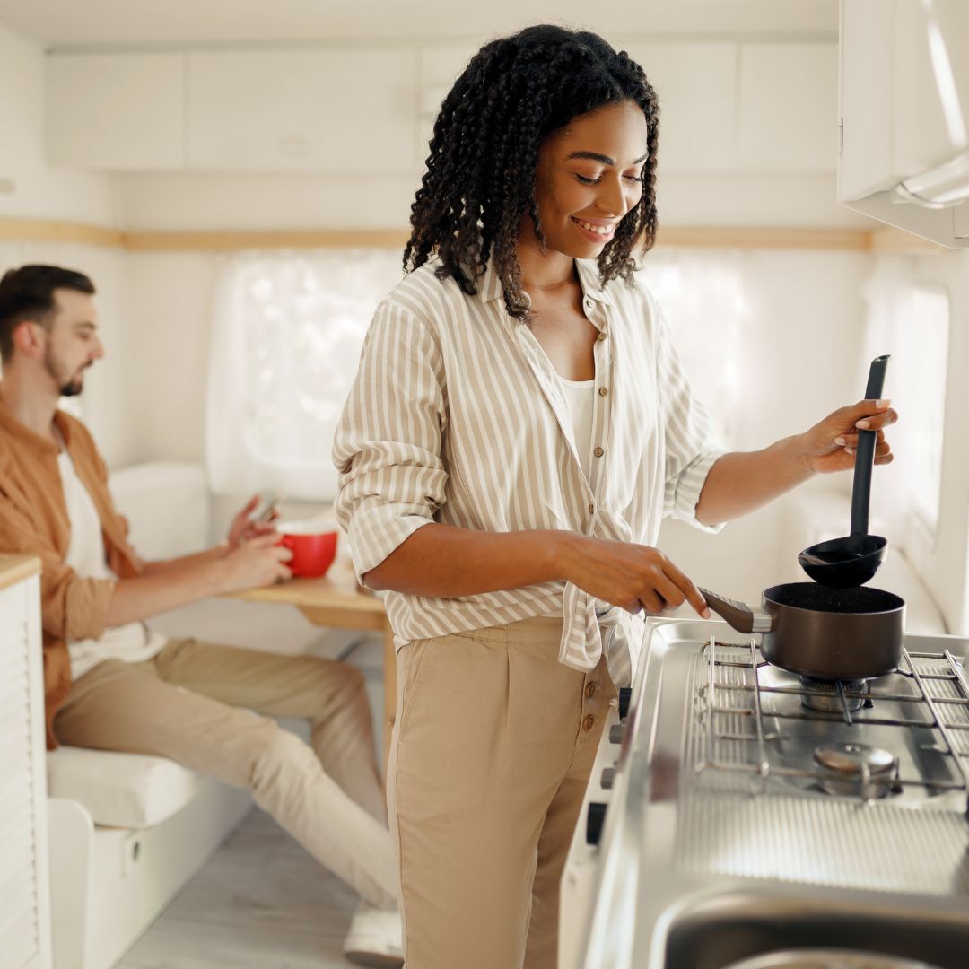 woman cooking in an RV