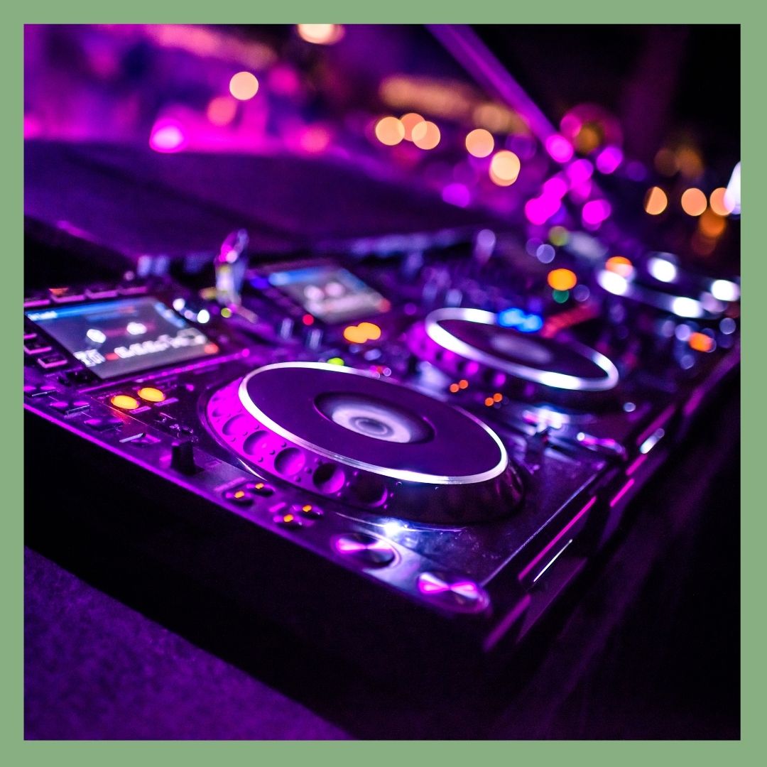 DJ equipment glowing with purple and blue lights.