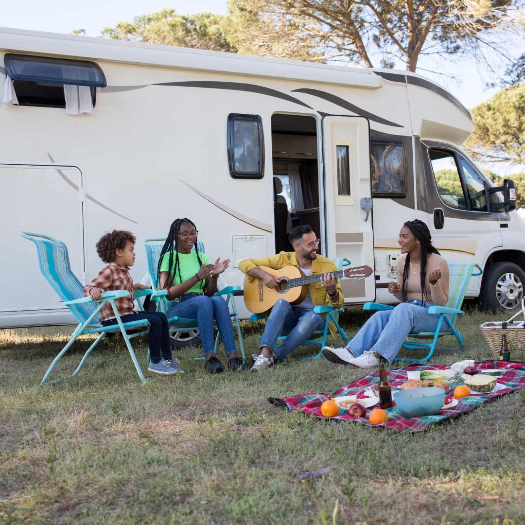 Family sitting around at an RV campground