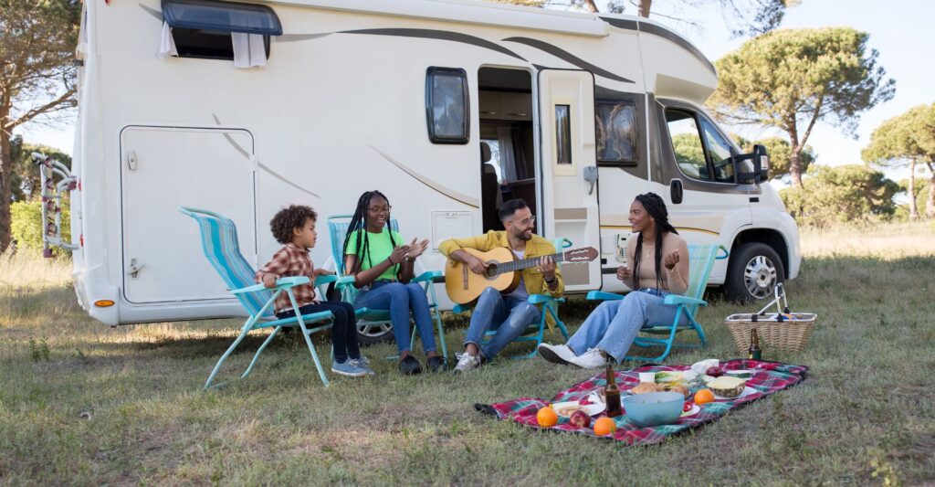 a family playing music outside of their RV